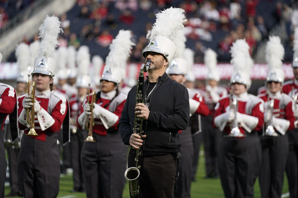 Jimmy Kimmel performs with the Washington State marching band before the L.A. Bowl at SoFi Stadium on Saturday.