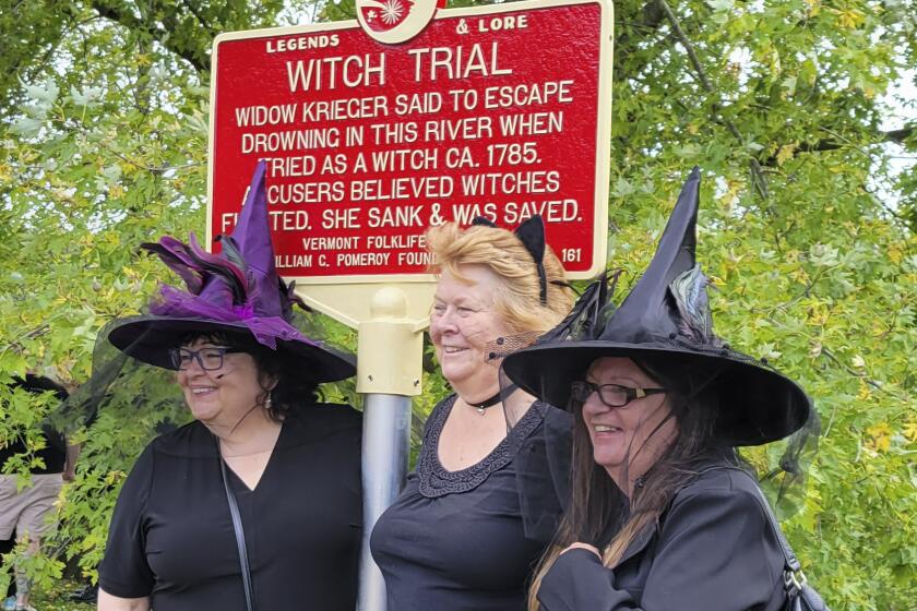En esta foto del 16 de setiembre de 2023, provista por Alexina Jones, mujeres vestidas de brujas se congregan frente a una nueva placa en Pownal, Vermont, que recuerda a la sobreviviente del único juicio por brujería celebrado en Vermont. (Alexina Jones via AP)