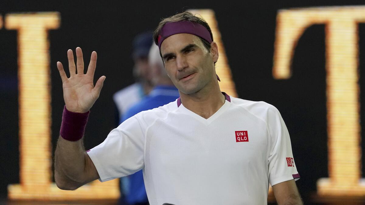 Switzerland's Roger Federer waves after defeating Tennys Sandgren of the U.S. in their quarterfinal match at the Australian Open tennis championship in Melbourne, Australia, Tuesday, Jan. 28, 2020. (AP Photo/Lee Jin-man)
