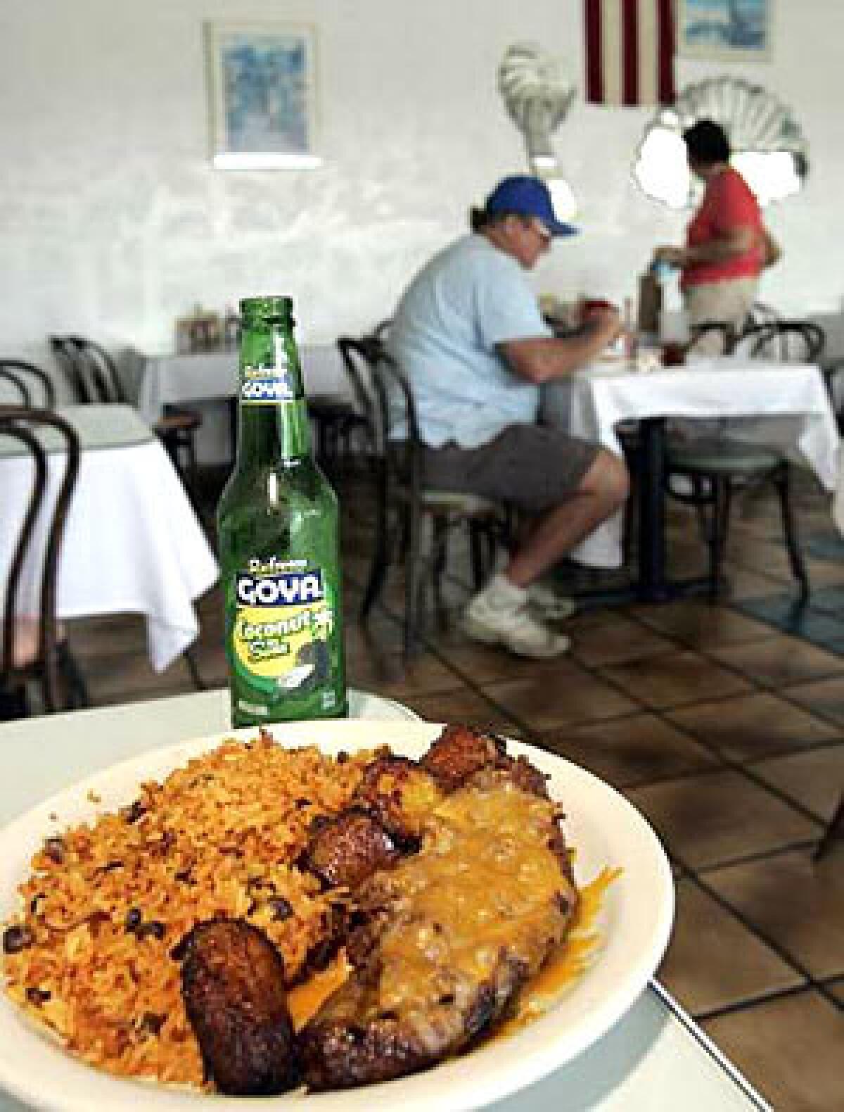 SWEETNESS: The canoa de plátano maduro, a caramelized yellow plantain loaded with ground beef and topped with cheddar, is served with Spanish rice.