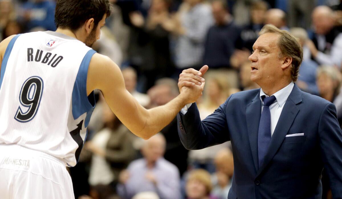 Timberwolves guard Ricky Rubio and Coach Flip Saunders celebrate after a 97-91 victory over the Pistons on Thursday.