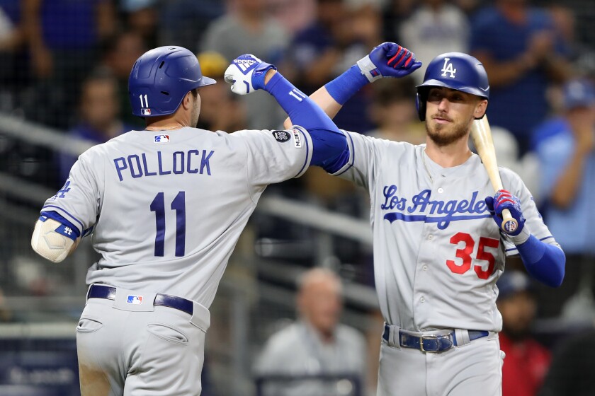 Cody Bellinger congratulates A.J. Pollock after his solo home run during the ninth inning against the Padres on Tuesday in San Diego.