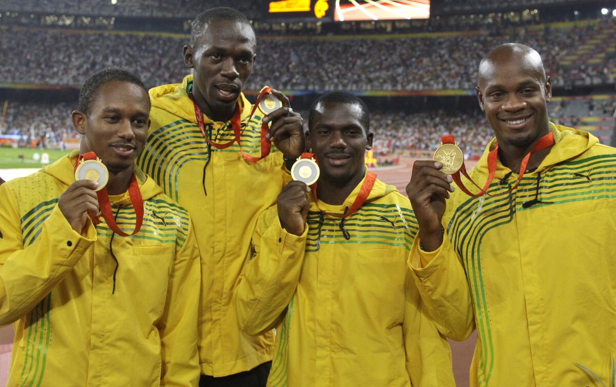 Jamaica's 400-meter relay team from the 2008 Beijing Olympics, from left, Michael Fraser, left, Usain Bolt, Nesta Carter and Asafa Powell. Carter's doping case has cost all four team members their gold medal, though he is appealing.