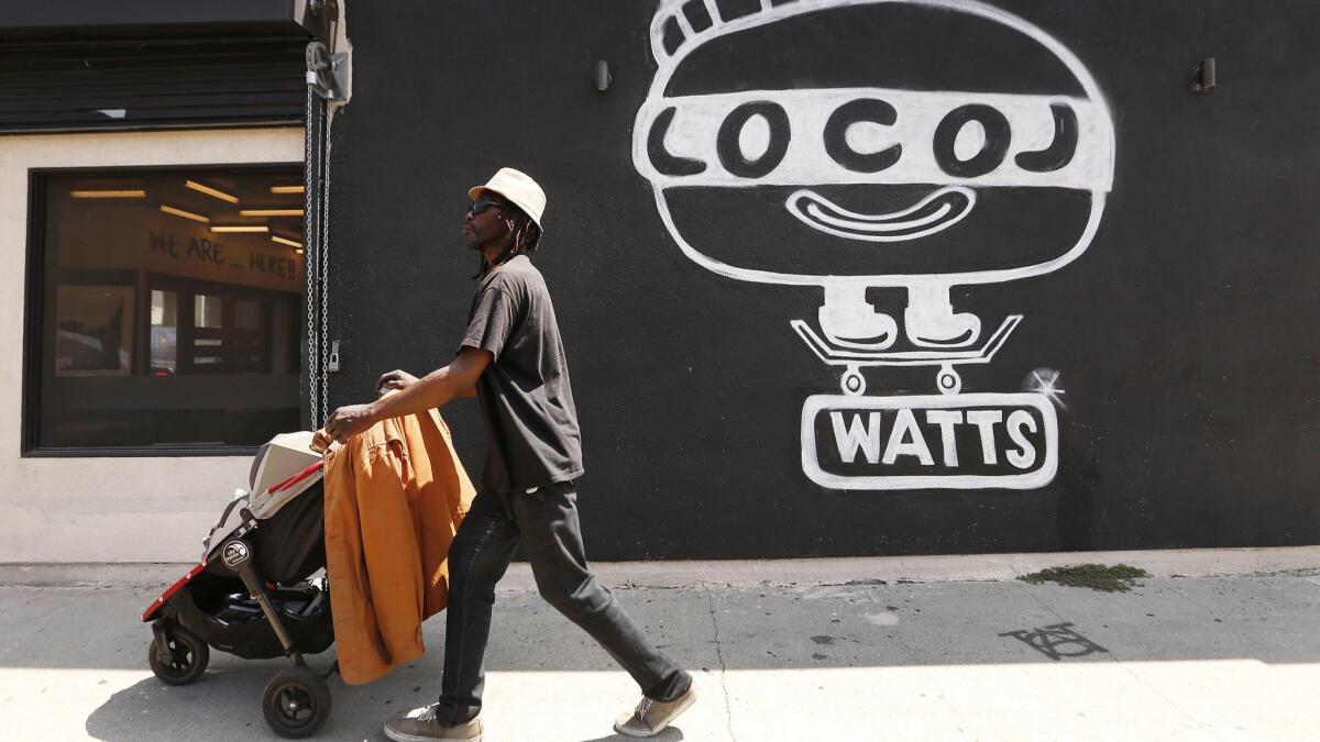 Eric Hayden walks past the Locol restaurant in Watts on Thursday.