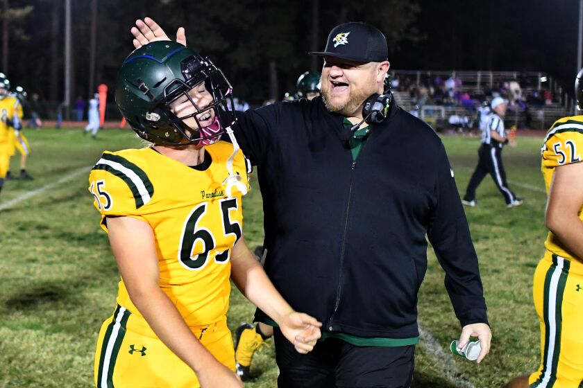 PARADISE, CALIFORNIA OCTOBER 18, 2019-Paradise High School coach Andy Hopper who had a medical emergency that early took his life a few weeks earlier celebrates with Aiden Luna as they defeat Willows 57-0 Friday night. (Wally Skalij/Los Angeles Times)