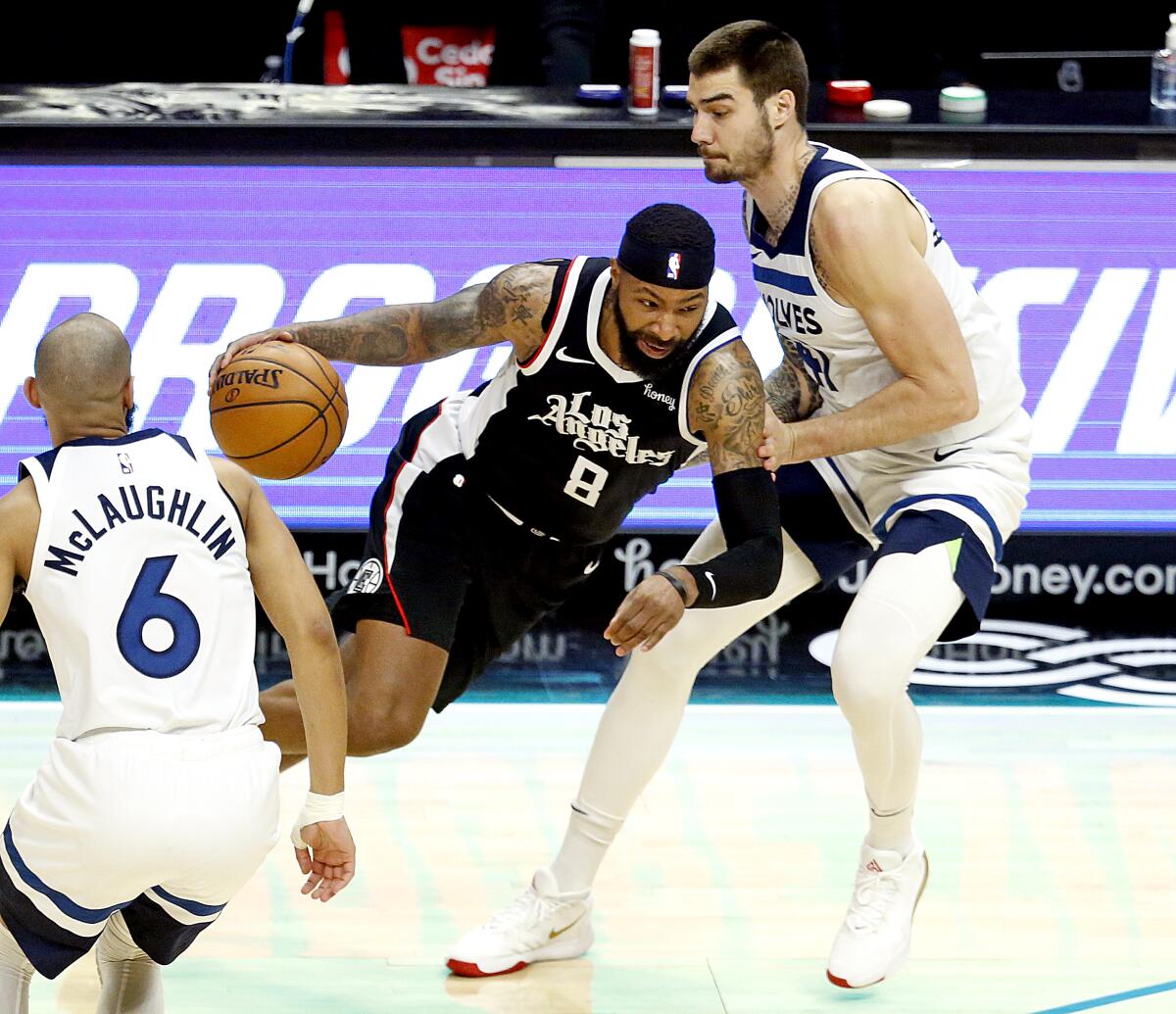 Clippers forward Marcus Morris Sr. drives to the basket against Timberwolves forward Juancho Hernangomez.