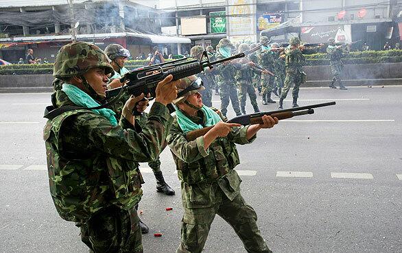 Soldiers fire at anti-government protesters along Rama 4 Road in Bangkok, Thailand. Protesters and military clashed in central Bangkok after the government launched an operation to disperse anti-government protesters who have closed parts of the city for two months.