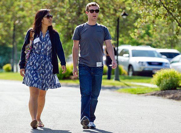 Mark Zuckerberg walks to morning sessions with his girlfriend, Priscilla Chan, during the Allen and Co. Sun Valley Conference in Sun Valley, Idaho, in July 2011.