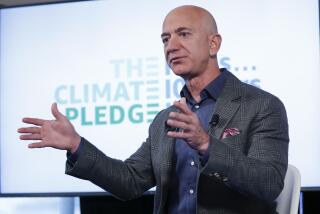 Amazon CEO Jeff Bezos arrives to begin his news conference at the National Press Club in Washington, Thursday, Sept. 19, 2019. Bezos announced the Climate Pledge, setting a goal to meet the Paris Agreement 10 years early. (AP Photo/Pablo Martinez Monsivais)