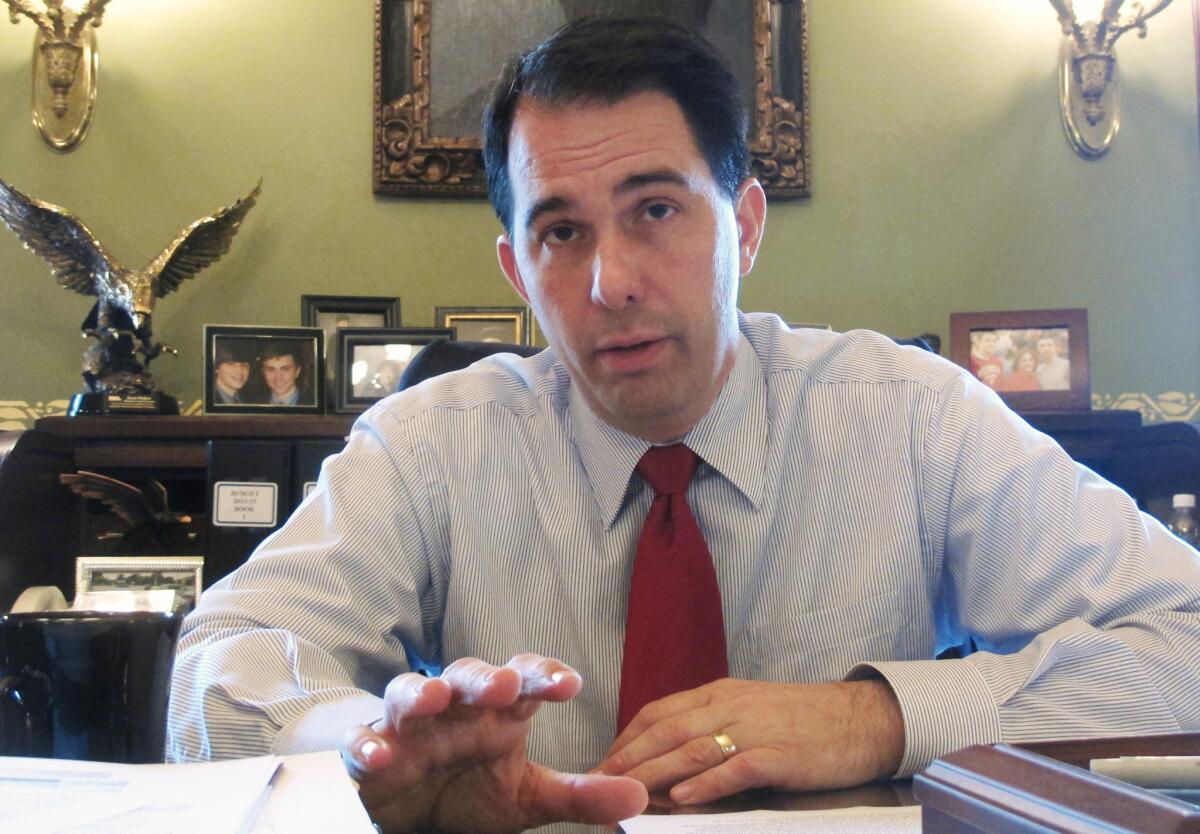 Wisconsin Gov. Scott Walker signed a contentious Republican bill Friday that would require women seeking an abortion to view an ultrasound of the fetus before the procedure. Opponents have sued to stop the law.