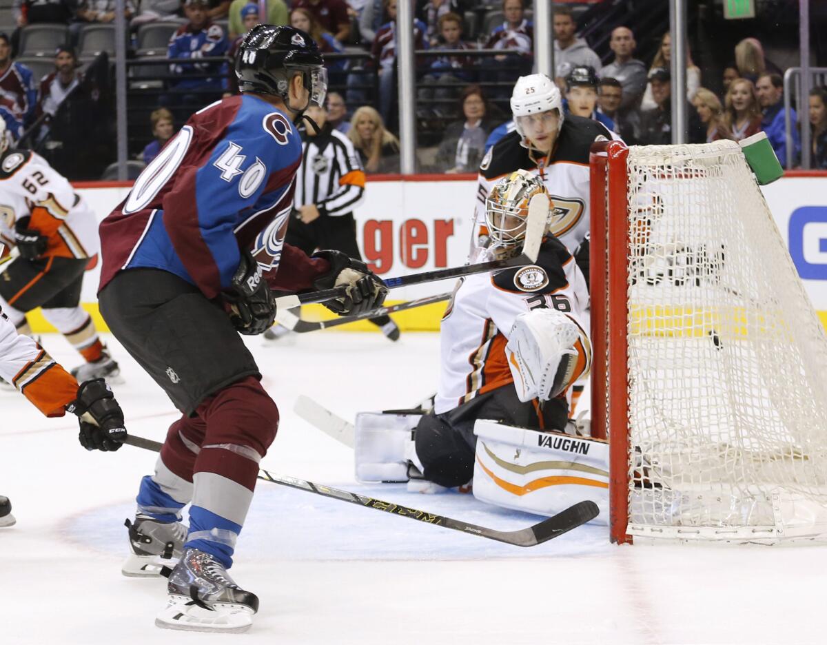 Avalanche forward Alex Tanguay slips the puck past Ducks goalie John Gibson for the game-winner during the overtime period of an preseason game Tuesday.