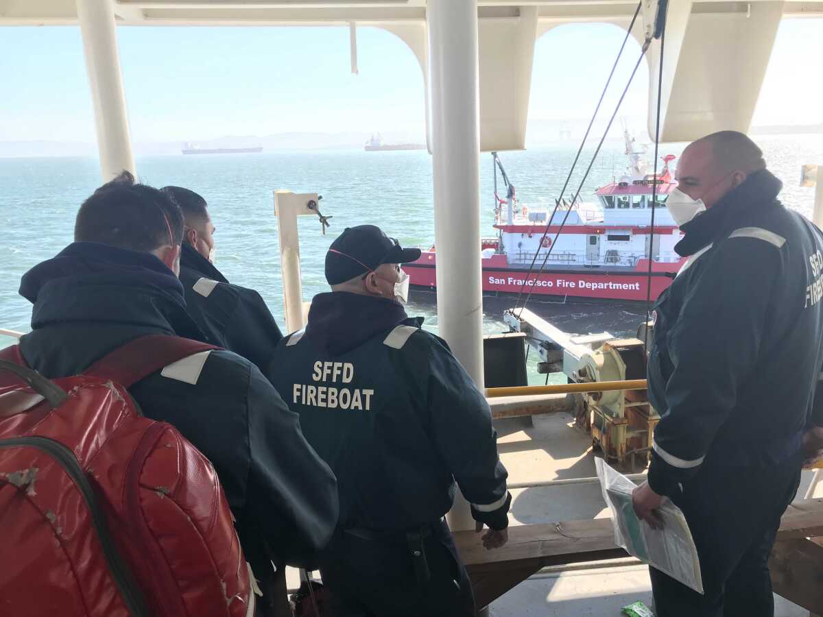 San Francisco firefighters rescue crew members on board a ship.