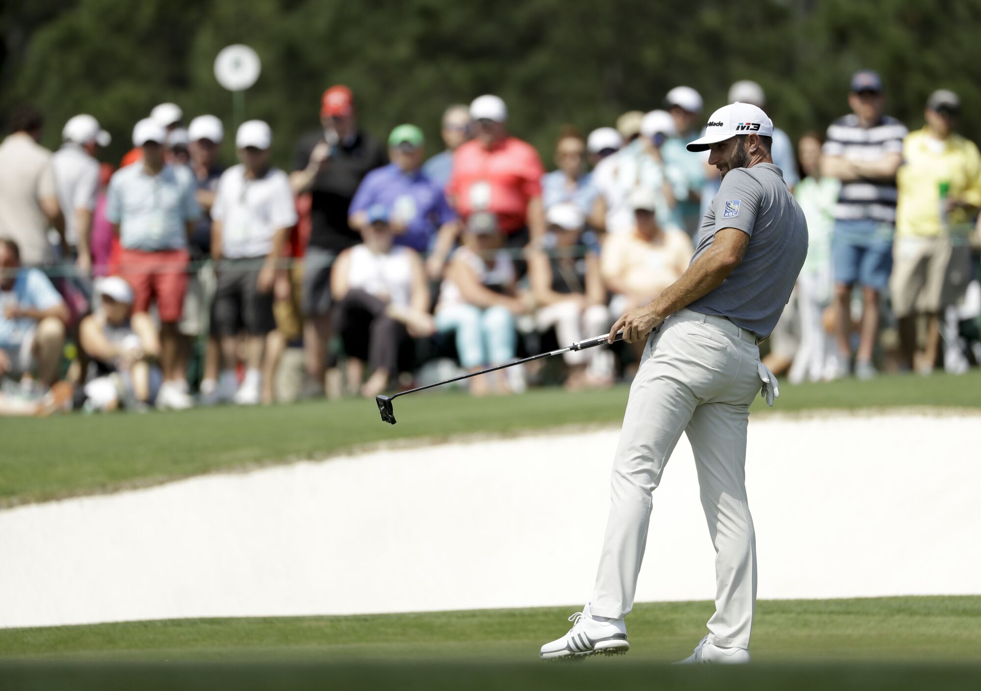 Dustin Johnson watches his putt on the 17th hole at Augusta National Golf Club.