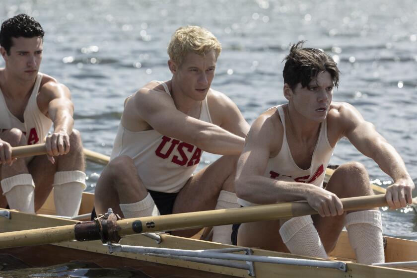 This image released by MGM Pictures shows Bruce Herbelin-Earle, from left, Callum Turner and Jack Mulhern in a scene from "The Boys in the Boat." (Laurie Sparham/Metro-Goldwyn-Mayer Pictures via AP)
