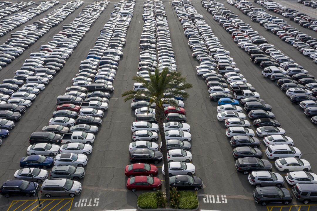 Rows of vehicles fill the Santa Anita racetrack parking lot. 