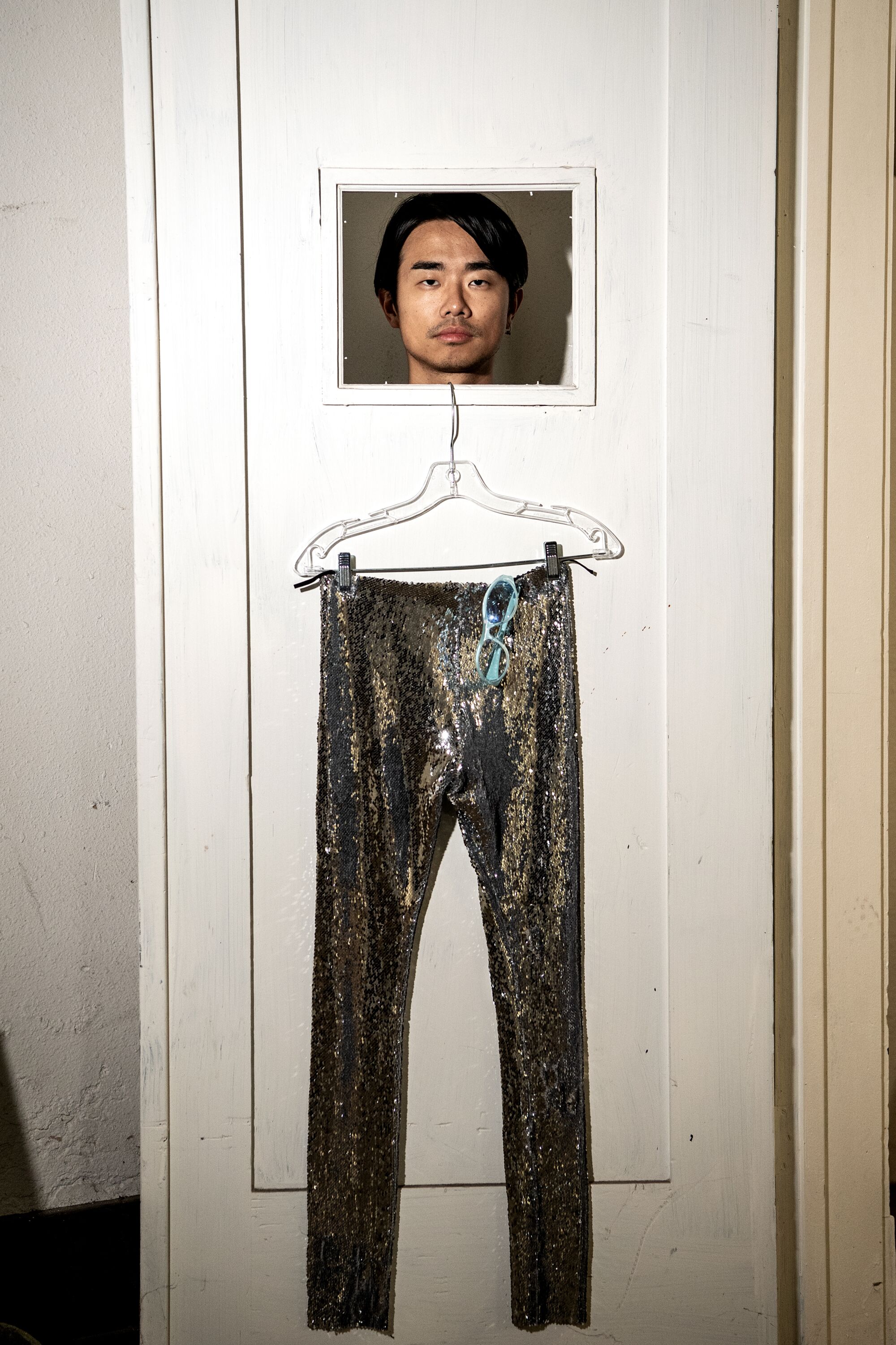 Shaojun Chen looking through a doorframe.