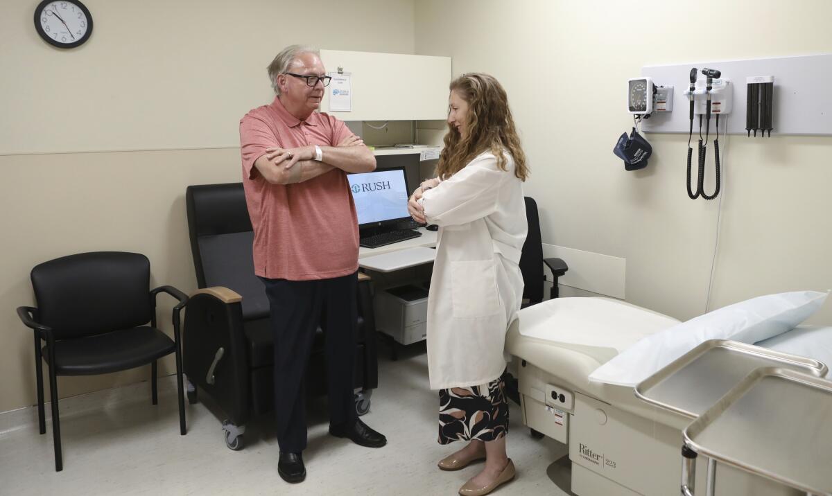 Dr. Jori Fleisher, a neurologist, examines Thomas Doyle, who hopes blood tests may someday replace the invasive diagnostic testing he endured to be diagnosed with Lewy body dementia.