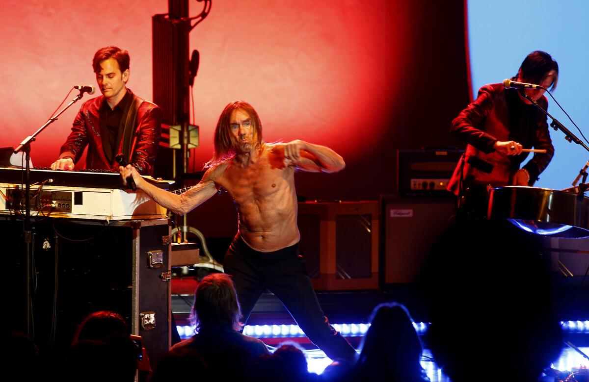 Iggy Pop, center, performs Thursday night at the Greek Theatre in Los Angeles.