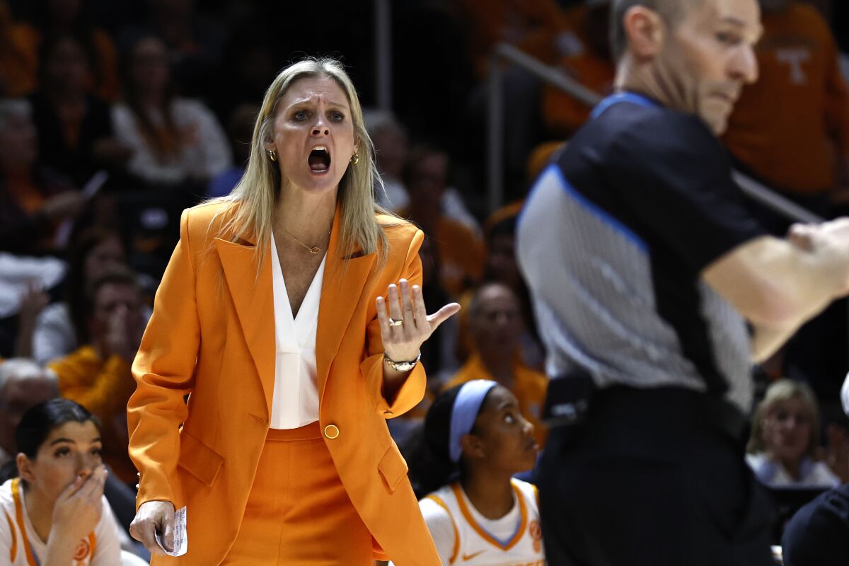 Tennessee head coach Kellie Harper, left, yells at an official during the second half of an NCAA college basketball game against UConn, Thursday, Jan. 26, 2023, in Knoxville, Tenn. (AP Photo/Wade Payne)