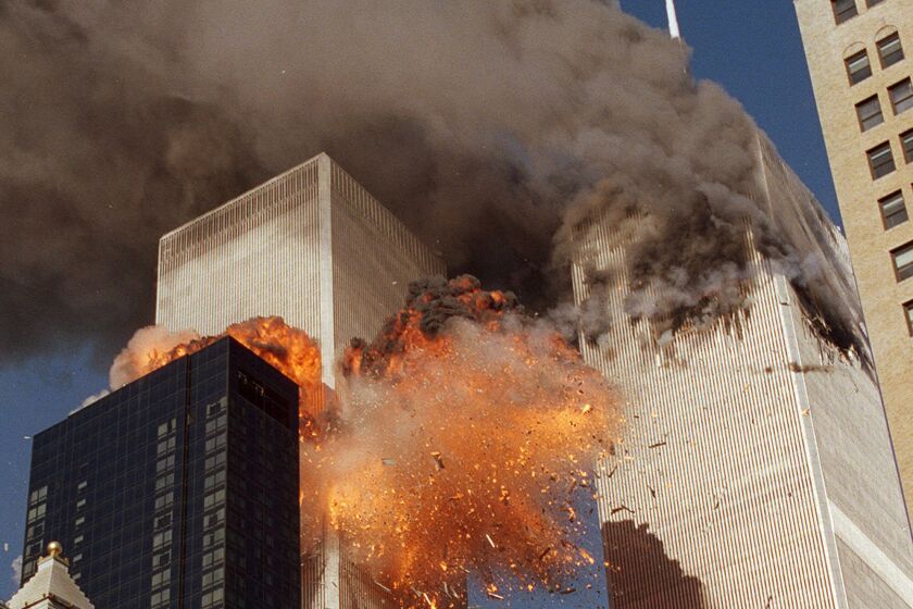 FILE - In this Sept. 11, 2001, file photo, smoke billows from one of the towers of the World Trade Center and flames as debris explodes from the second tower in New York. Relatives of the victims of the Sept. 11 attacks called Thursday, Sept. 2, for the Justice Department's inspector general to investigate the FBI's failure to produce certain pieces of evidence from its investigation. (AP Photo/Chao Soi Cheong, File)
