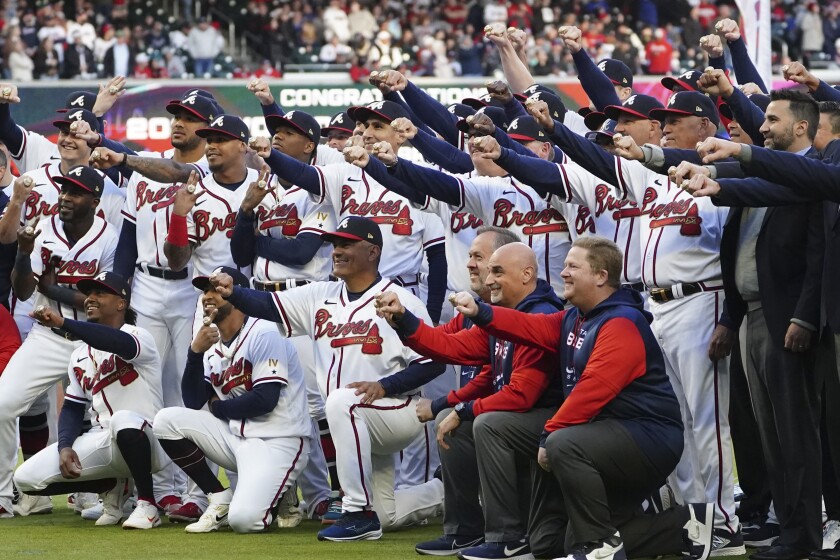 Atlanta Braves players, coaches and staff pose with their World Series rings.
