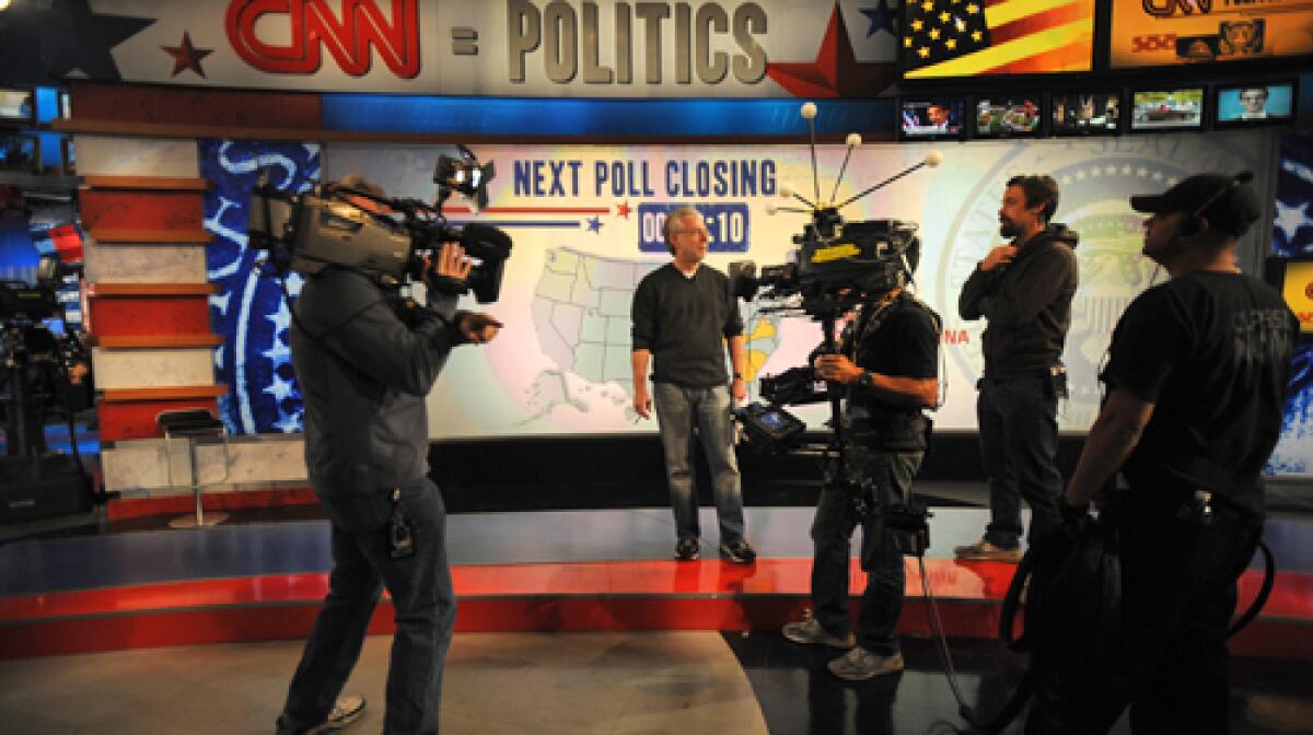 BUILDING EXCITEMENT: Anchor Wolf Blitzer, center, and CNN crew members rehearse. The network plans to use hologram technology on set.