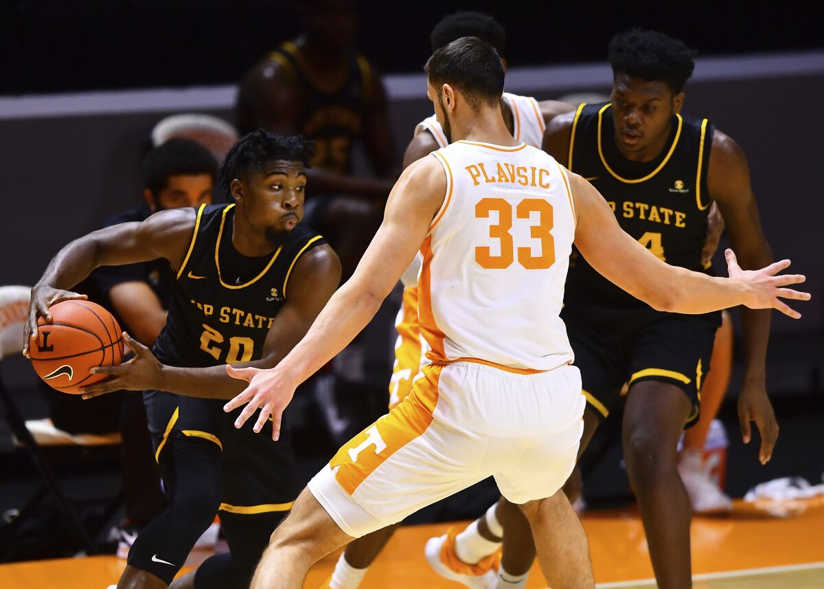 Appalachian State guard Adrian Delph (20) tries to move past Tennessee forward Uros Plavsic (33) during an NCAA college basketball game in Knoxville, Tenn., on Tuesday, Dec. 15, 2020. (Brianna Paciorka/Knoxville News Sentinel via AP)