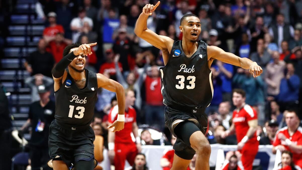 Nevada's Josh Hall (33) and Hallice Cooke (13) celebrate after Cincinnati failed to get get off a potential game-winning shot.