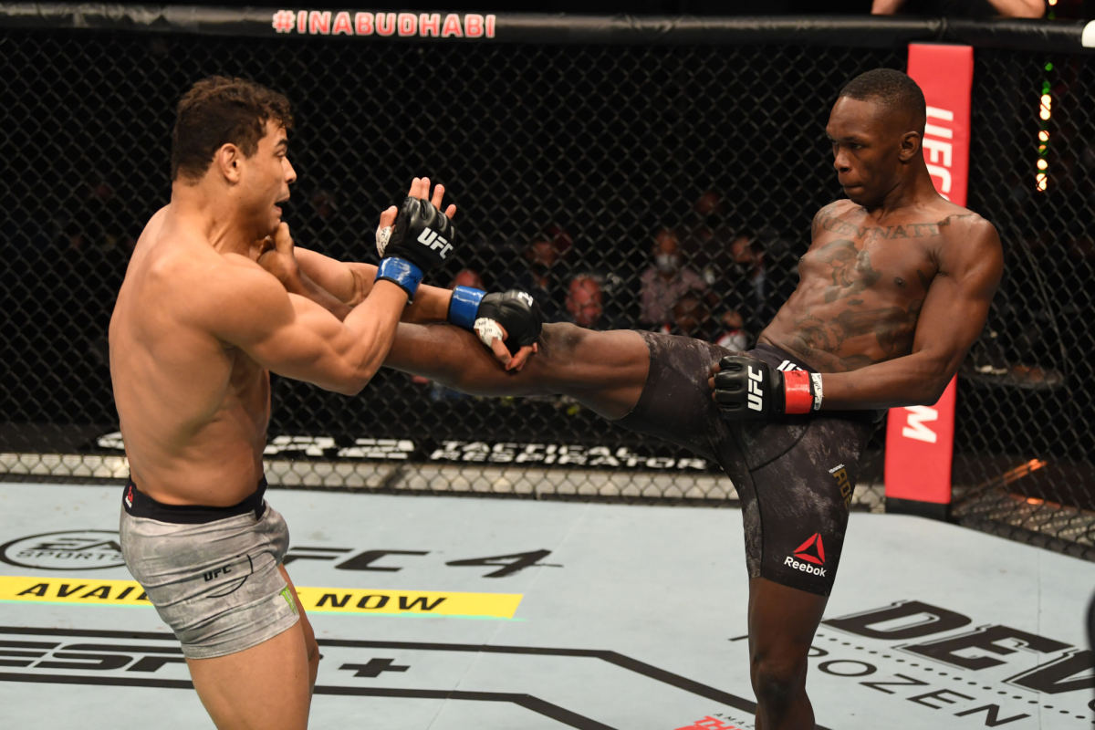 Israel Adesanya kicks Paulo Costa during their middleweight title bout at UFC 253 on Sunday.