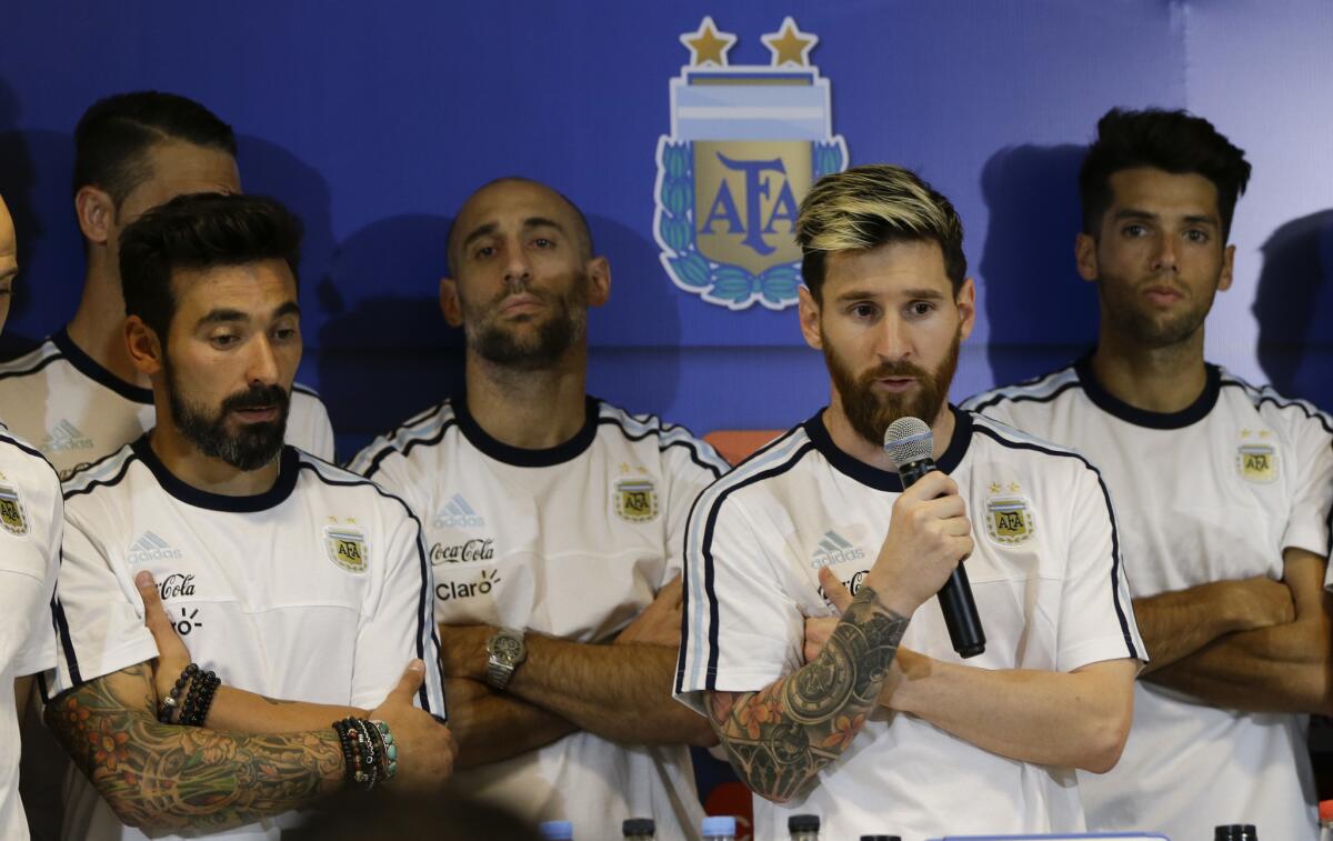 Argentina's Lionel Messi is surrounded by the teammates as he speaks after a World Cup qualifying match against Colombia on Nov. 16.