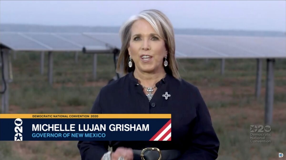 New Mexico Gov. Michelle Lujan Grisham addresses the Democratic National Convention, with solar panels in the background.