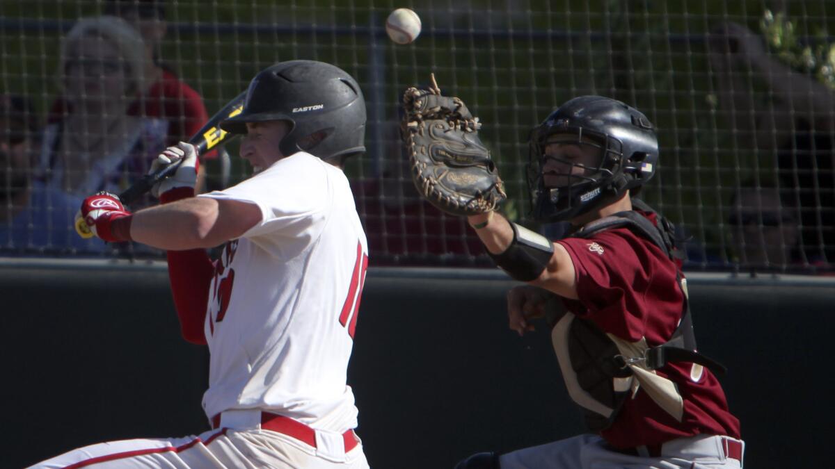 Harvard-Westlake's Matt Karo fouls off a bunt in front of Alemany catcher Rece Reagan during a April 29 game.
