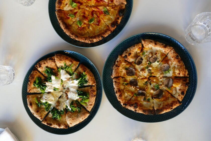 Il Dandy, one of the most creative restaurants in San Diego, has the most unique pizza crust in town. Pictured are the Bankers Hill restaraurant’s (clockwise from top) La Nostra Margherita, with yellow and red cherry tomatoes, buffalo mozzarella and basil, the Buongustaia, with pumpkin, guanciale, fresh truffle, hazelnuts and percorino, and the Rustichella, with rapini, burrata and maialino nero sausage.