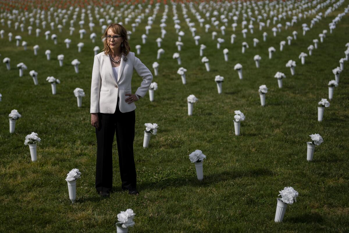 Gabrielle Giffords stands at a Gun Violence Memorial installation on the National Mall