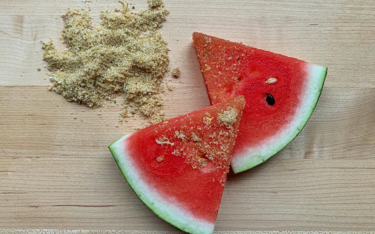 Two slices of watermelon dipped in a spice mix.