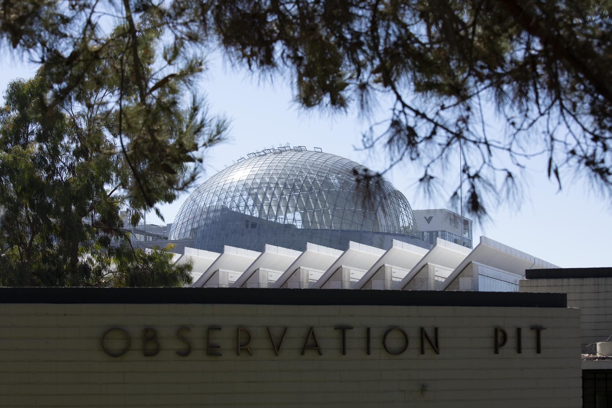 The spherical shape of the Geffen Theater pokes out above the roofs of a Tar Pits observation building and BCAM