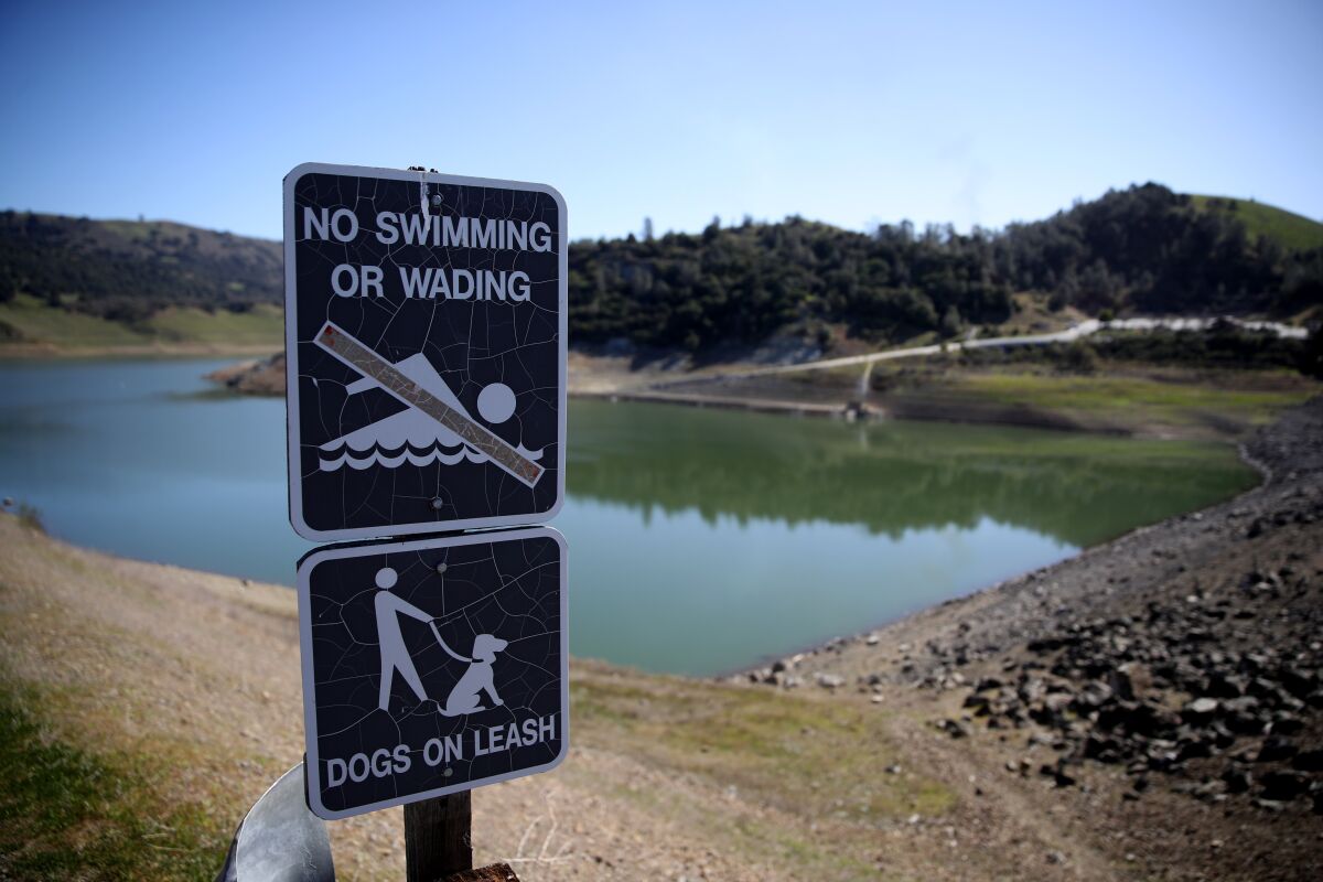 A "no swimming" sign is posted at Anderson Reservoir in Morgan Hill, Calif. 
