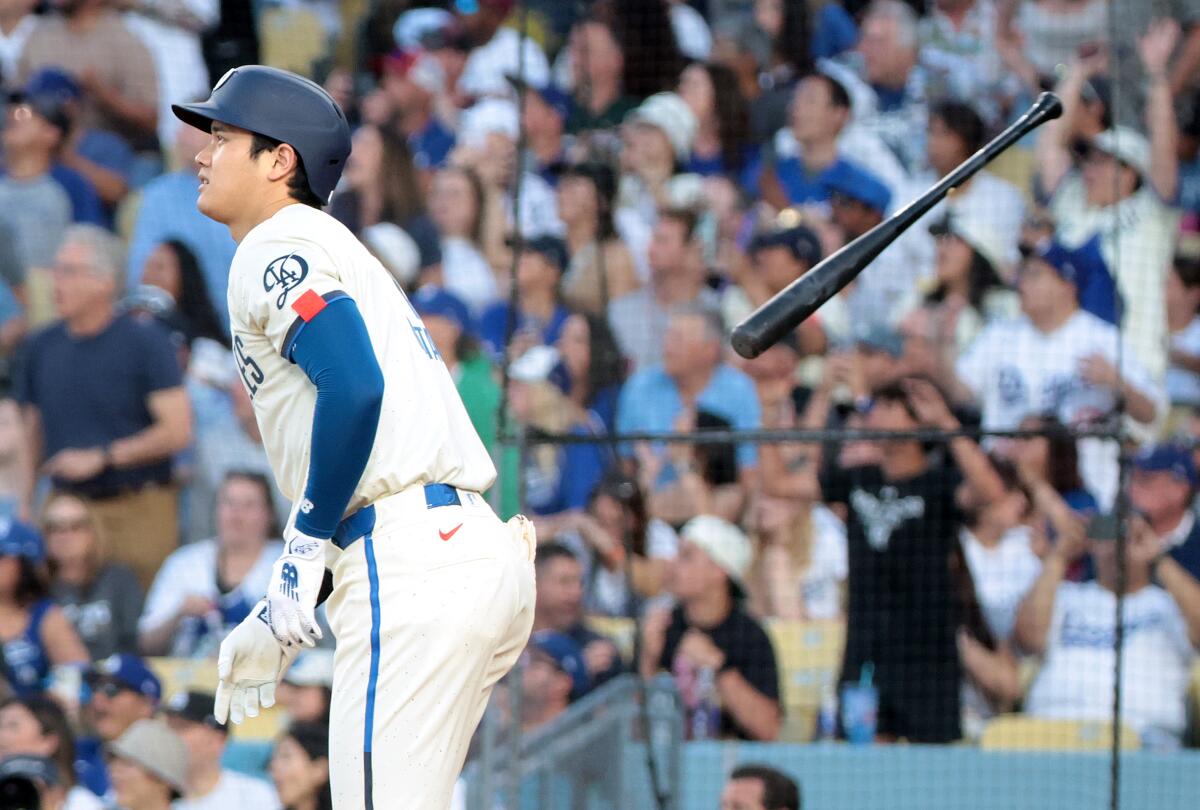 Dodgers star Shohei Ohtani tosses his bat after hitting a two-run home run in the third inning.