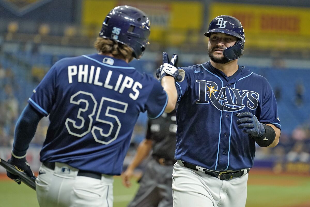 Tampa Bay Rays' Mike Zunino, right, celebrates with Brett Phillips after his solo home run off Seattle Mariners relief pitcher Drew Steckenrider during the sixth inning of a baseball game Wednesday, Aug. 4, 2021, in St. Petersburg, Fla. (AP Photo/Chris O'Meara)