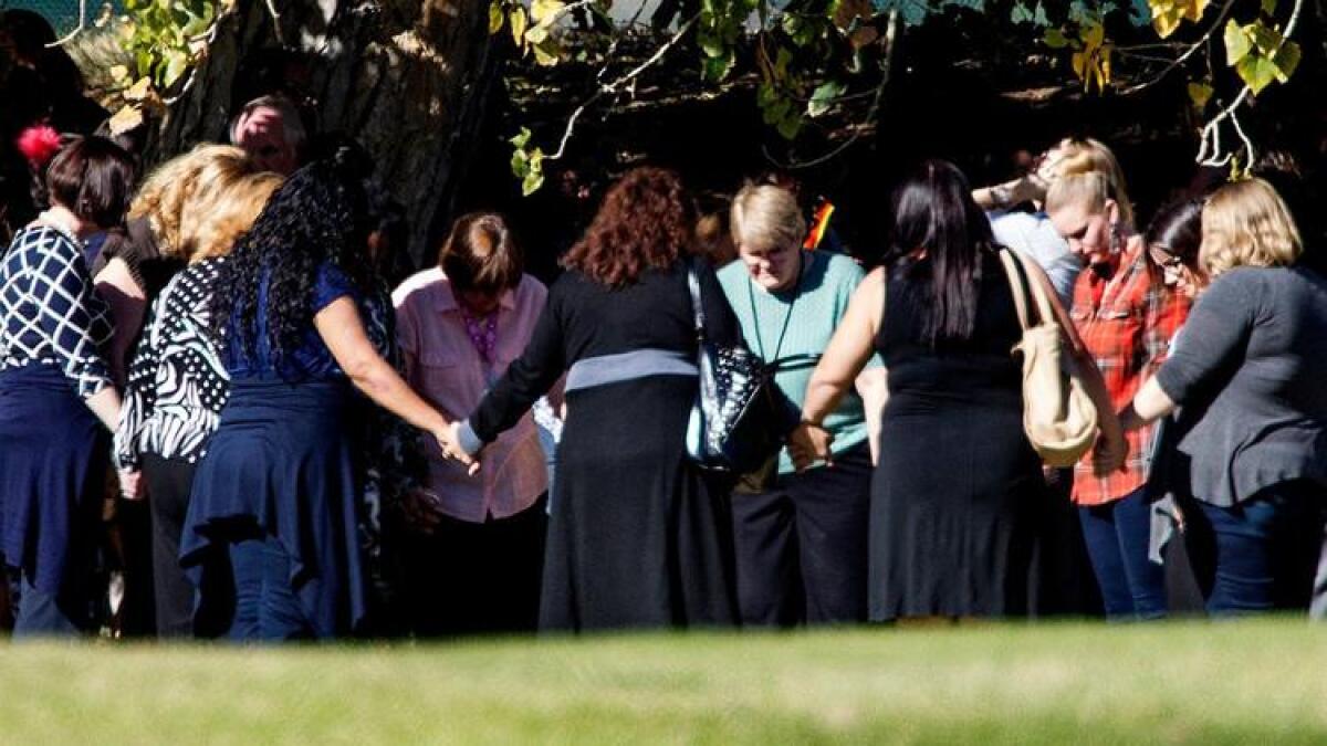 Evacuated workers pray on the fairway of the San Bernardino Golf Club shortly after the 2015 mass shooting at the nearby Inland Regional Center.