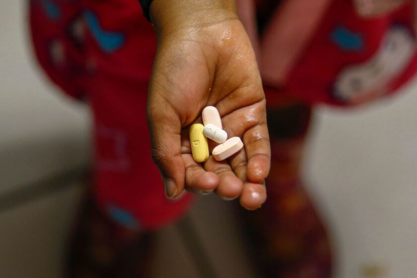 epa05603322 YEARENDER 2016 JULY A South African child holds Antiretroviral (ARV) drugs prior to the daily routine of medicine taking at the HOKISA childrens home in Masiphumelele, Cape Town, South Africa 19 July 2016. HOKISA stands for Homes For Kids In South Africa, where children living with and affected by HIV and AIDS are cared for. When a child cannot be looked after by family members or neighbours, he or she is placed via the Magistrate's Court at the HOKISA home. South Africa was hosting the 2016 International Aids Conference from 18 to 22 July. South Africa has the biggest and most high profile HIV epidemic in the world, with an estimated 6.5 million people living with HIV. EPA/NIC BOTHMA ** Usable by LA, CT and MoD ONLY **