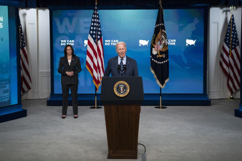 Vice President Kamala Harris listens as President Joe Biden speaks about the COVID-19 vaccination program, in the South Court Auditorium on the White House campus, Wednesday, June 2, 2021, in Washington. (AP Photo/Evan Vucci)