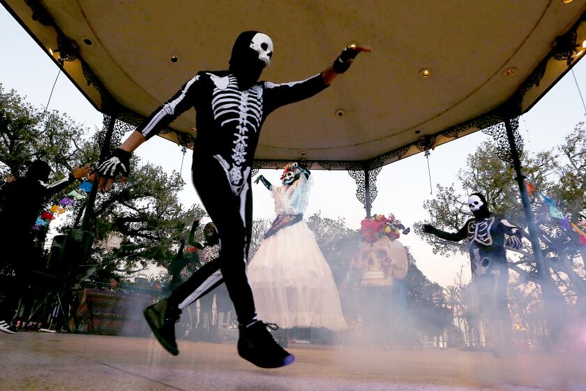 Los Angeles, CA - Dancers in skeleton costues dance at Olvera Plaza during Day of the Dead festivities at Olvera Plaza in Los Angeles on Wednesday, Nov. 1, 2023. (Luis Sinco / Los Angeles Times)