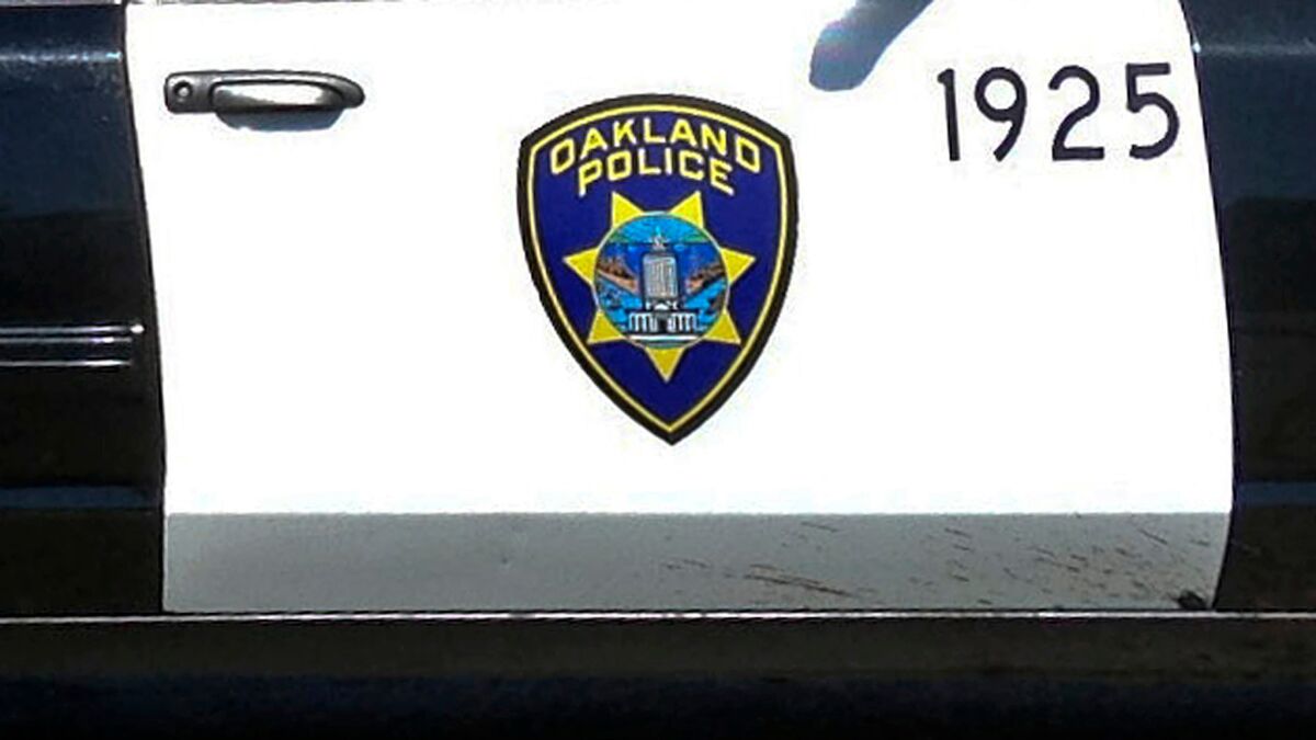 Oakland Police logo on the side of a patrol car