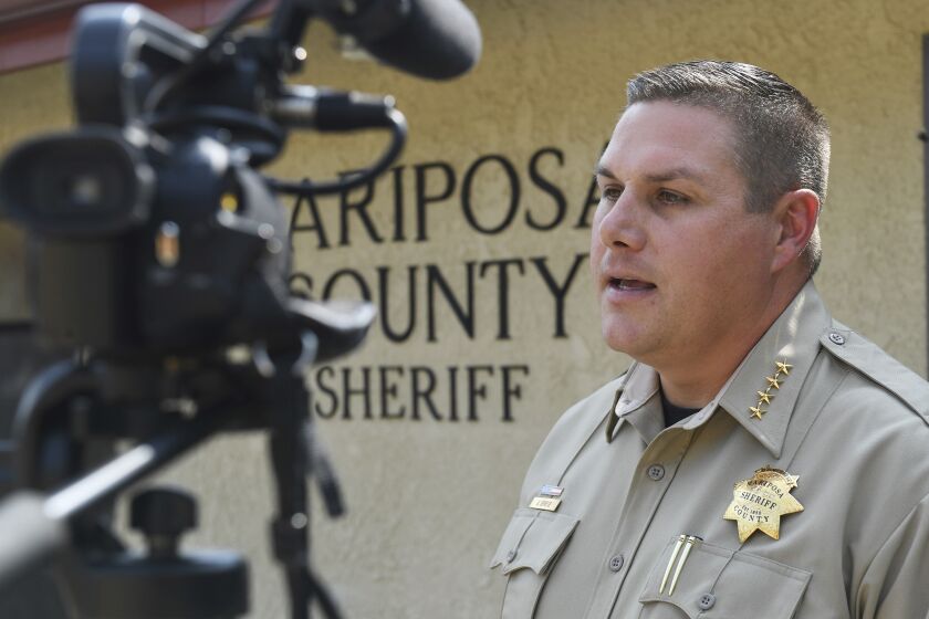 Mariposa County Sheriff Jeremy Briese gives an update on the investigation into the deaths of three family members and their dog in the Hite Cove area of the Sierra National Forest in Mariposa County, Calif., on Wednesday, Aug. 18, 2021. Investigators are considering whether toxic algae blooms or other hazards may have contributed to the deaths of a Northern California couple, their baby and the family dog on a remote hiking trail, authorities said. (Craig Kohlruss/The Fresno Bee via AP)