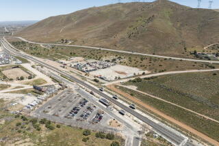 LOS ANGELES COUNTY, CA - APRIL 16: A proposed battery storage site (center light area) across from the Vincent Grade Metrolink station (bottom) in Acton has residents worried about the potential for fire in a fire-prone area and the impact on their home values. Photographed on Tuesday, April 16, 2024. (Myung J. Chun / Los Angeles Times)
