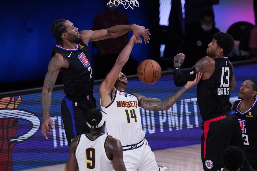 Denver Nuggets guard Gary Harris (14) is blocked by Los Angeles Clippers forward Kawhi Leonard (2) during the second half of an NBA conference semifinal playoff basketball game Tuesday, Sept. 15, 2020, in Lake Buena Vista, Fla. (AP Photo/Mark J. Terrill)