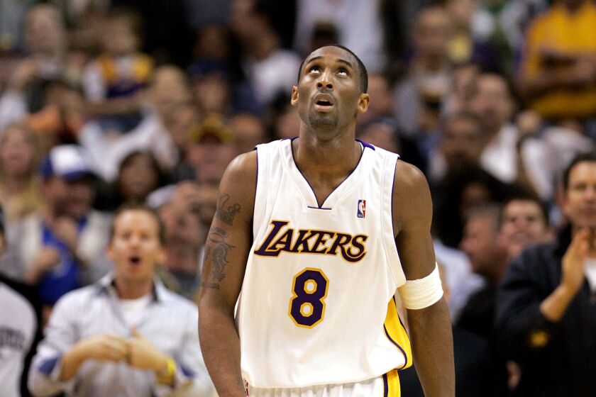 Kobe Bryant looks up at the Staples Center scoreboard and his 81-point total during the final seconds of a 122-104 victory over the Toronto Raptors on Jan. 22, 2006.