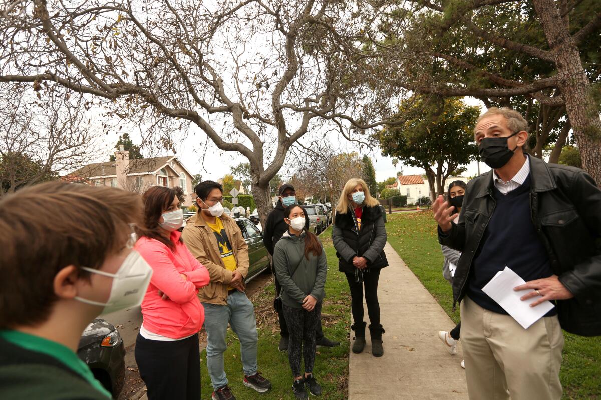 A man talks to a group of people outside