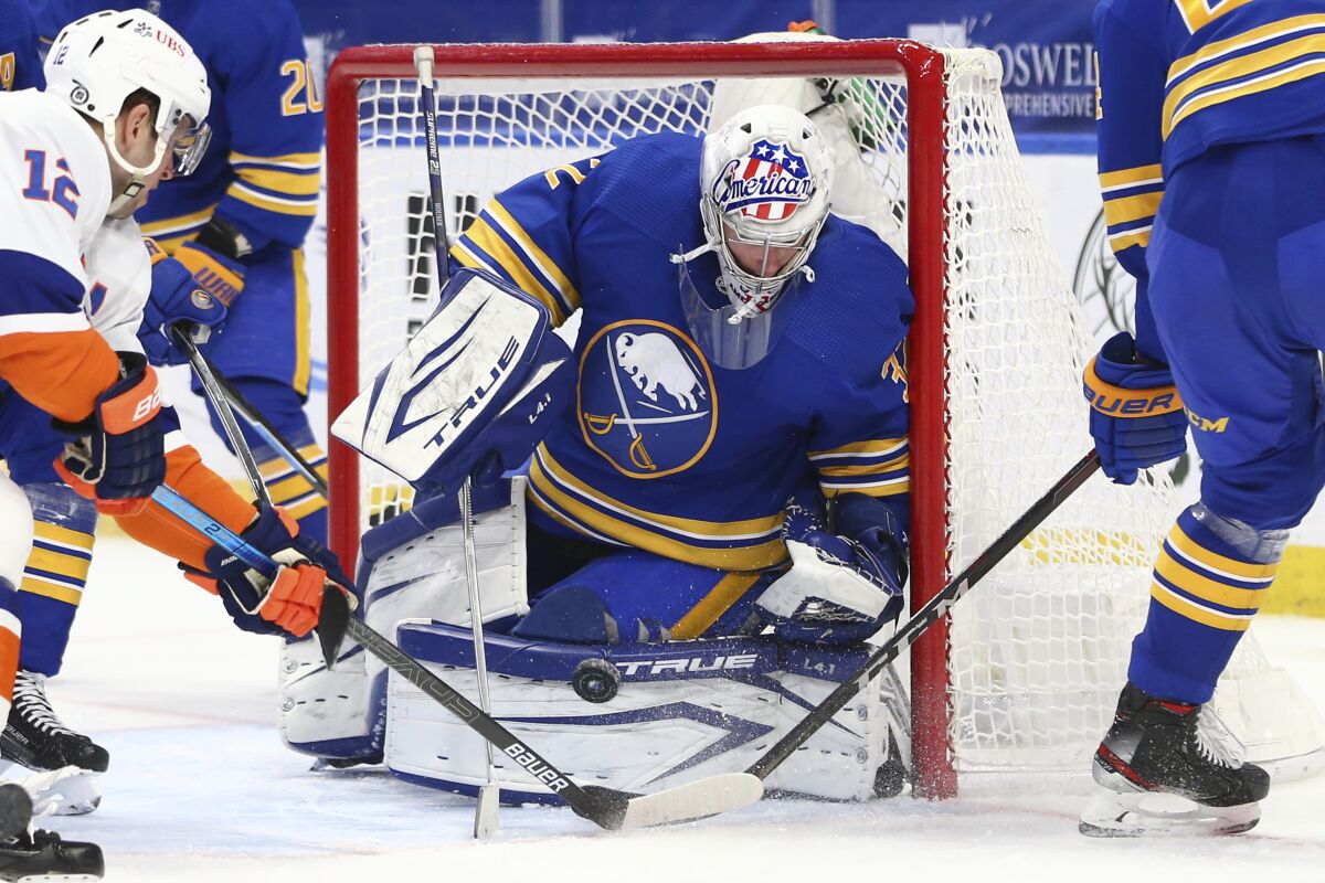 Buffalo Sabres goalie Michael Houser (32) makes a save in traffic during the second period of an NHL hockey game against the New York Islanders, Tuesday, May 4, 2021, in Buffalo, N.Y. (AP Photo/Jeffrey T. Barnes)